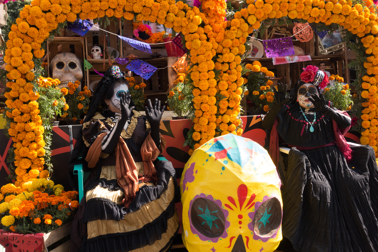 Mexico City, Mexico - October 29, 2016: Old Women on Marigold Flower Parade Floats During the Day of the Dead